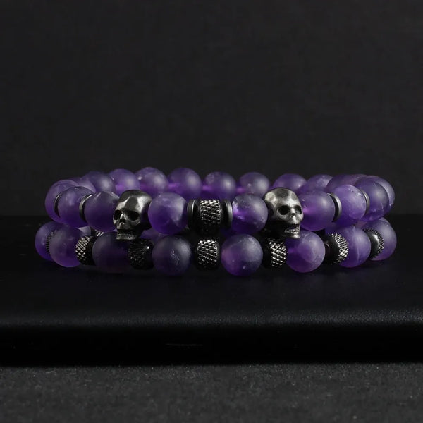Two-piece Amethyst Stone Skull Bracelet Set featuring purple beaded bracelets with metal skull elements