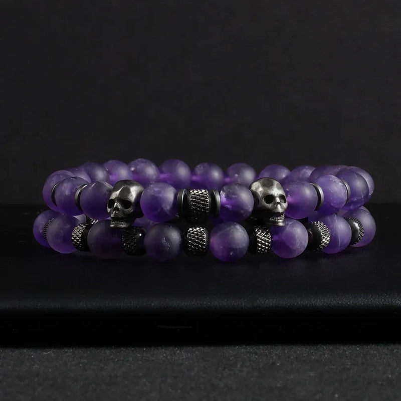 Two-piece Amethyst Stone Skull Bracelet Set featuring purple beaded bracelets with metal skull elements