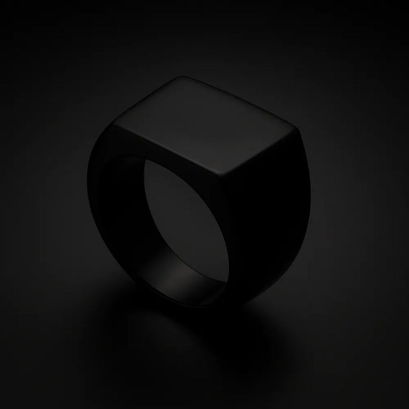 Black stainless steel signet ring with minimalist square face, matte finish, and masculine look
