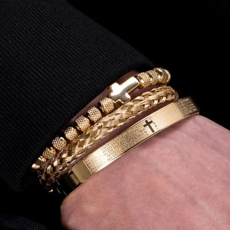 Men wearing gold symbol bracelet set with textured designs and engraved text on wrist