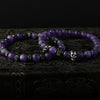 Amethyst Stone Skull Bracelet Set displayed on dark surface with matte purple gemstone beads and stainless-steel skull accents