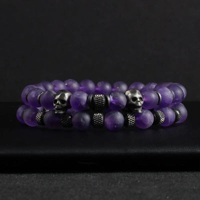 Two-piece Amethyst Stone Skull Bracelet Set featuring purple beaded bracelets with metal skull elements