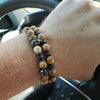 Khaki Stone Skull Bracelet Set worn on wrist with natural stone beads and stainless-steel skull accents