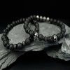 Two-piece Lava Stone Skull Bracelet Set displayed on dark surface with volcanic texture beads and skull elements