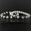 Two-piece White Stone Skull Bracelet Set with matte white marble beads and metal skull elements arranged for product display