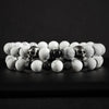White Stone Skull Bracelet Set displayed on dark surface featuring two beaded bracelets with marble-pattern beads and skull accents