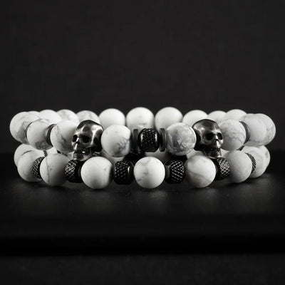 White Stone Skull Bracelet Set displayed on dark surface featuring two beaded bracelets with marble-pattern beads and skull accents